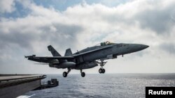 FILE - A U.S. Navy F/A-18E Super Hornet launches from the flight deck of the aircraft carrier USS Dwight D. Eisenhower in the Mediterranean Sea, June 28, 2016.